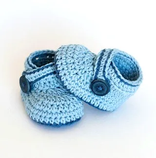 Adorable crochet baby booties in light blue with stylish accents