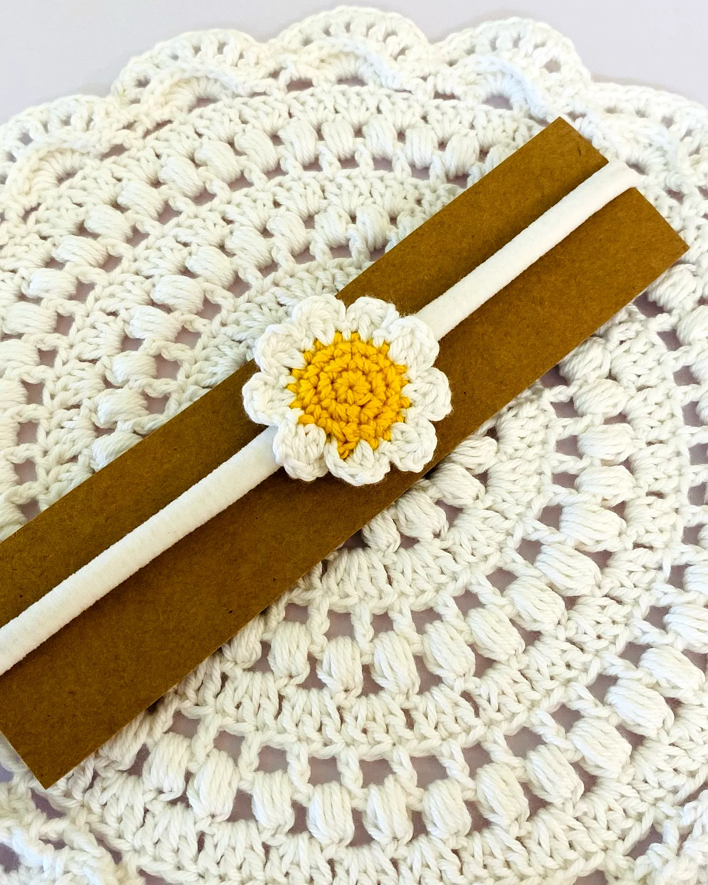 Adorable crochet baby headband with vibrant yellow daisy