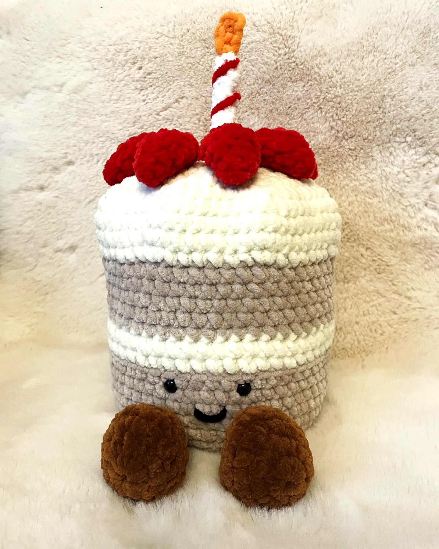 Adorable crochet cake in soft colors with cherry and candle