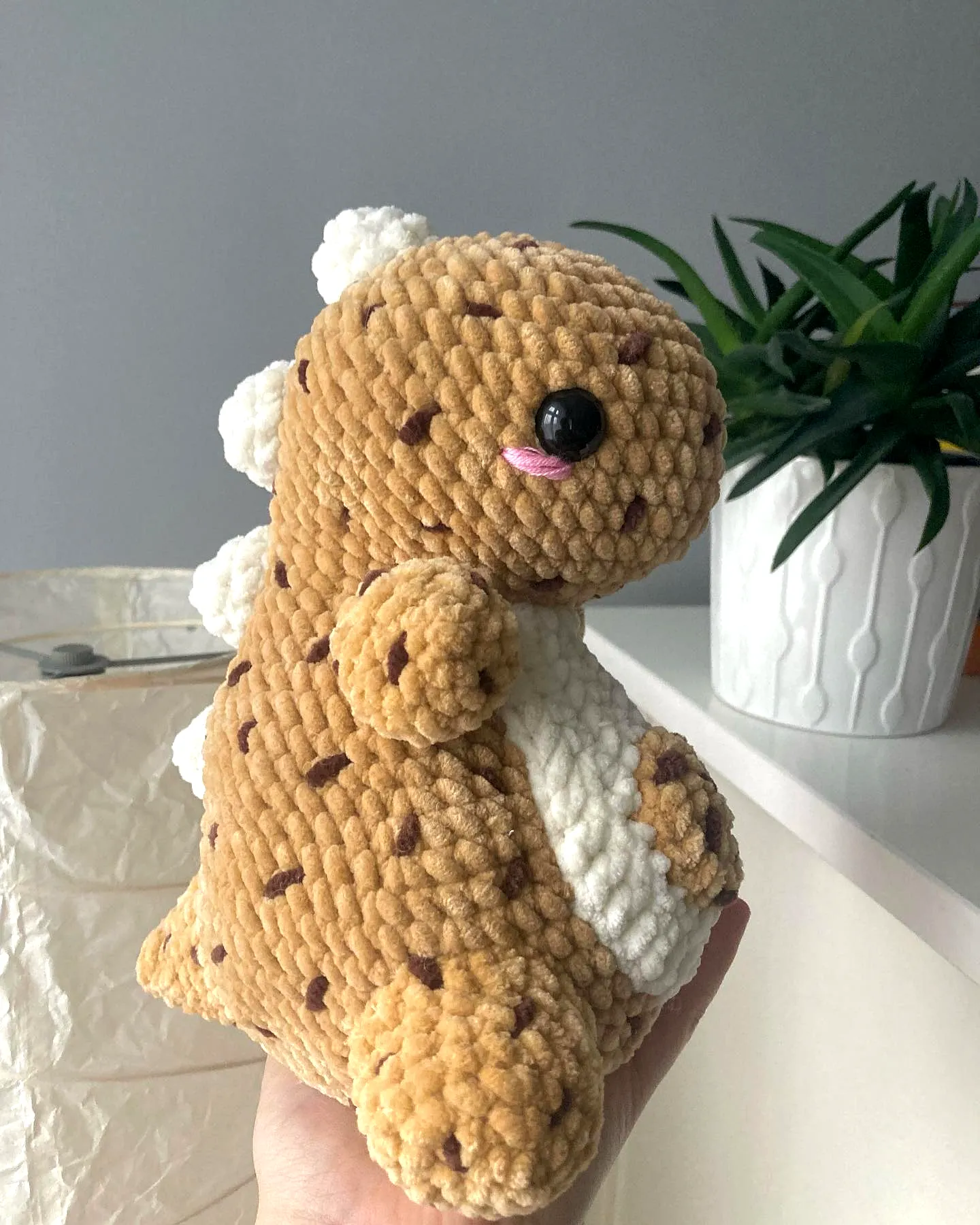 Adorable crochet cookie plushie in dinosaur style and colors