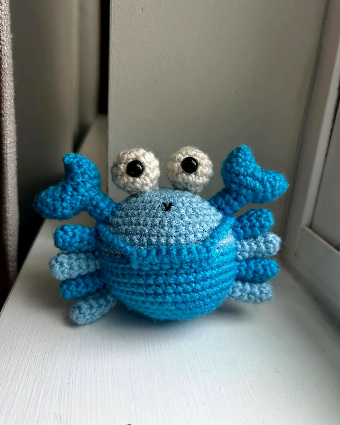 Adorable crochet crab in playful amigurumi style with soft colors