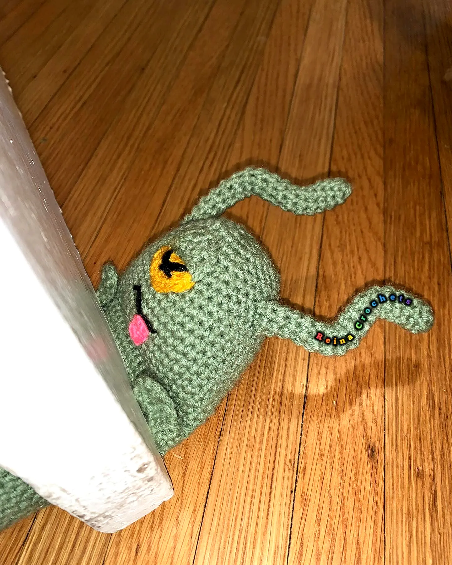 Adorable Crochet Doorstop in Soft Green with Colorful Details