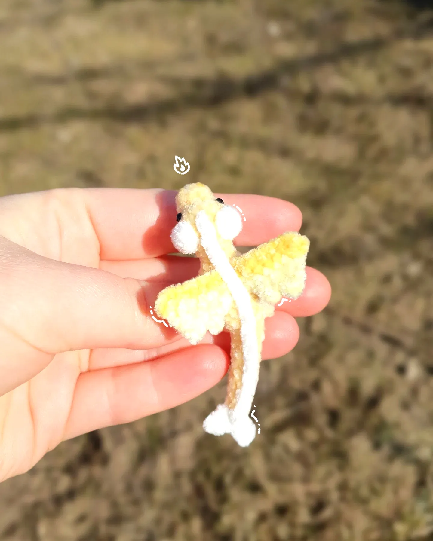 Adorable crochet dragon in soft yellow and white hues for intermediates