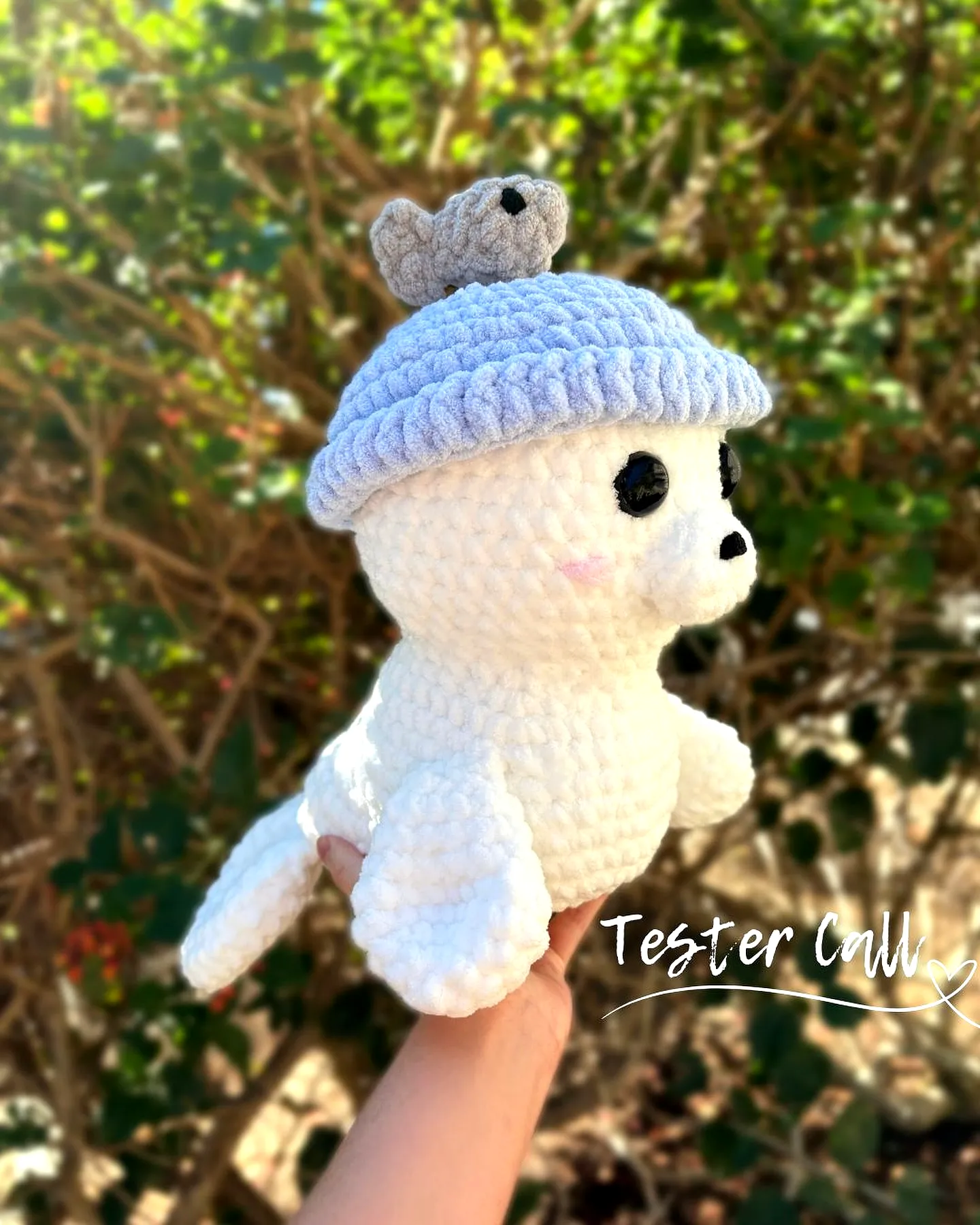 Adorable crochet fish toy in soft white and light blue colors