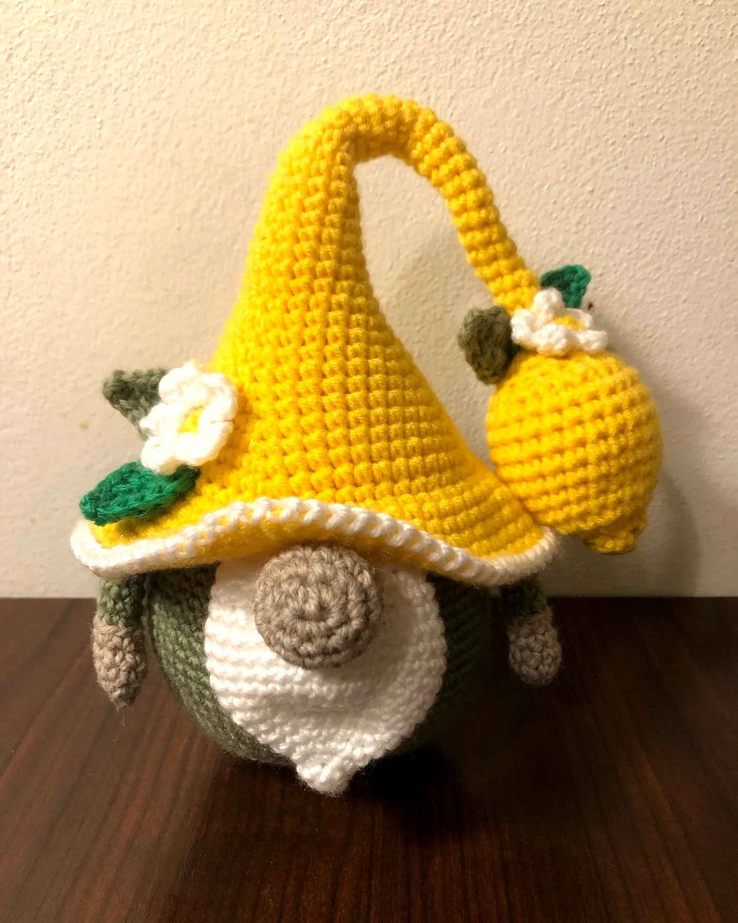 Adorable crochet gnome in earthy tones with vibrant yellow hat