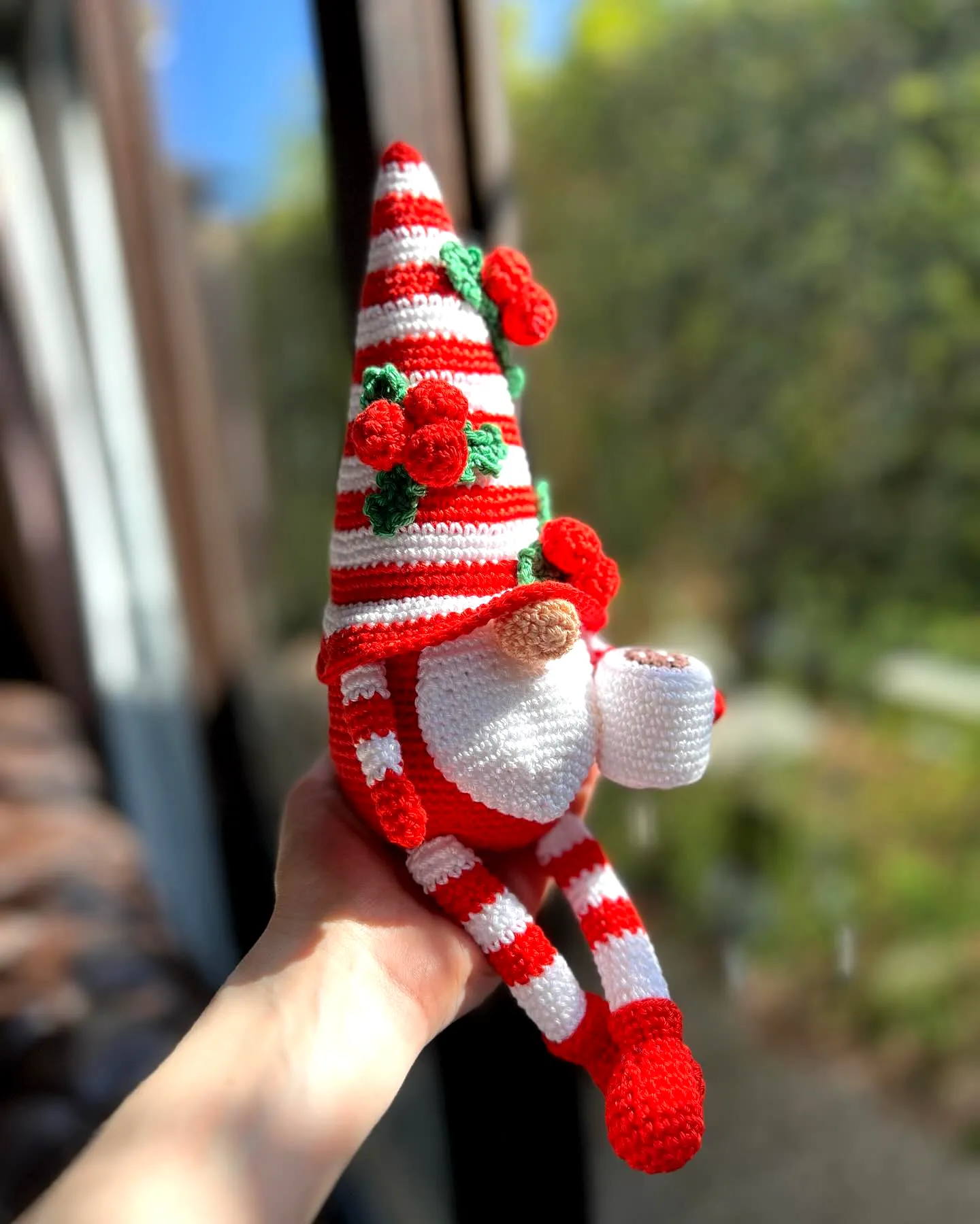 Adorable Crochet Gnome with Striped Hat and Red Flowers