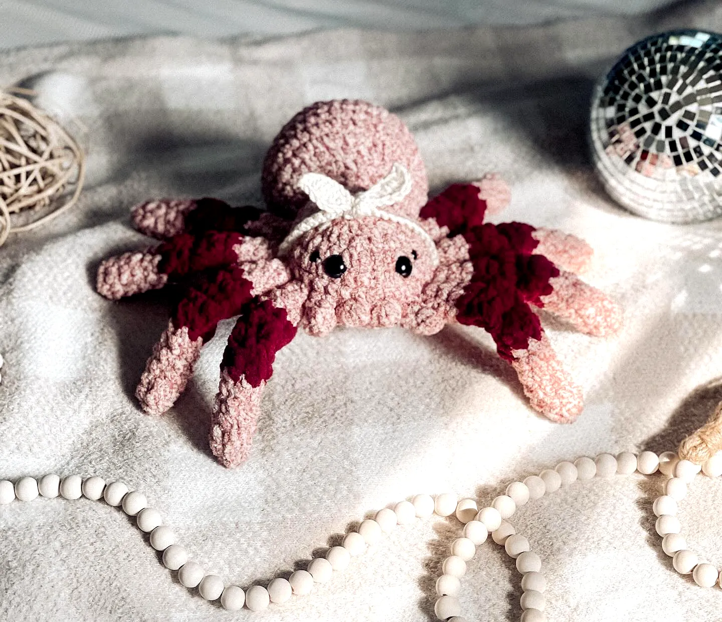 Adorable crochet spider in soft pink and burgundy style