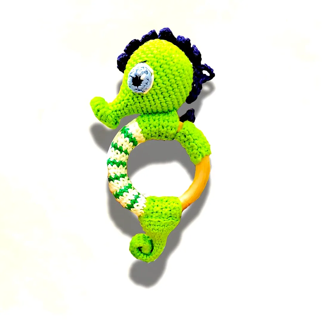 Adorable crochet teether in vibrant green and purple seahorse design