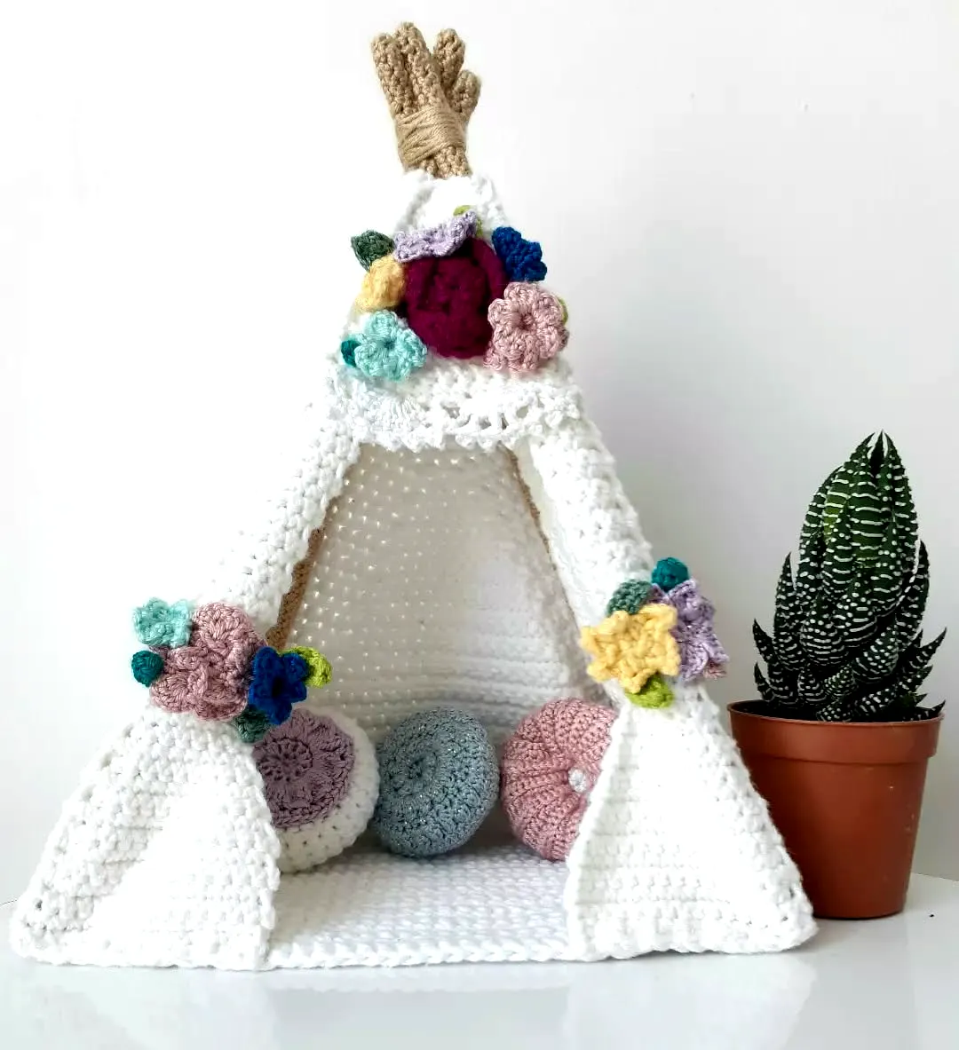 Adorable crochet tent in soft white with colorful accents