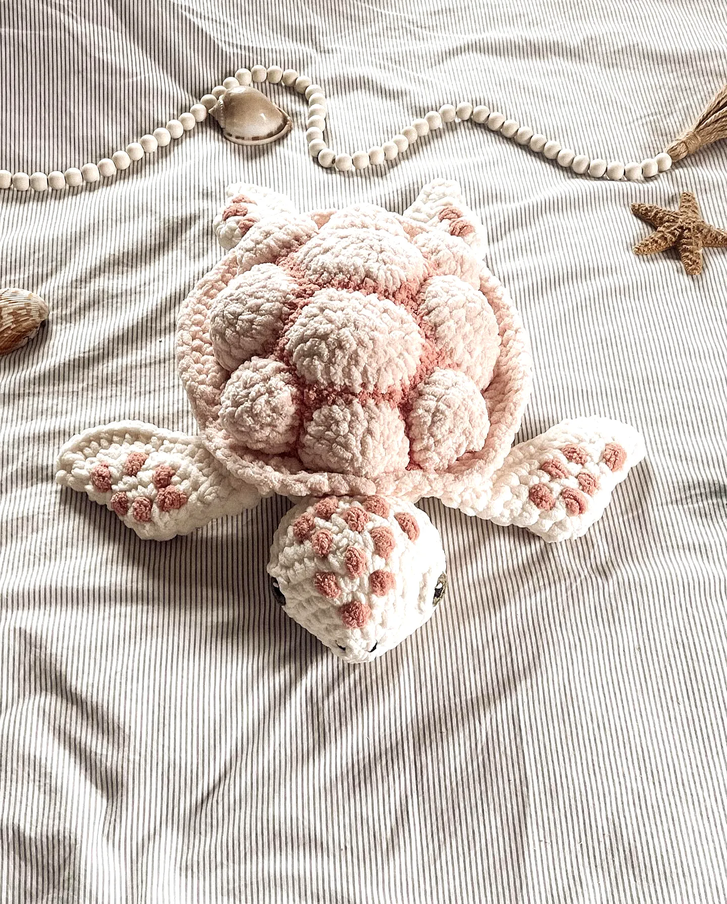 Adorable crochet turtle with pink and white fluffy shell