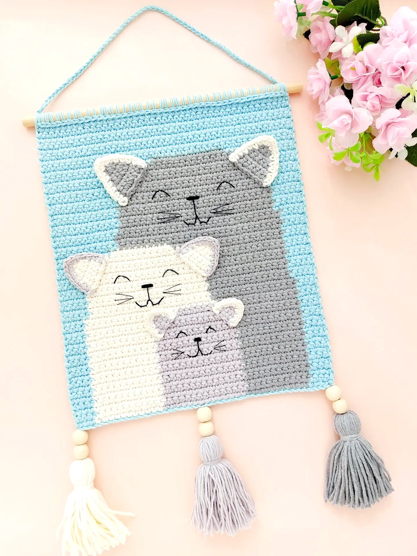 Adorable Crochet Wall Hanging of Cartoon Cats in Pastel Colors