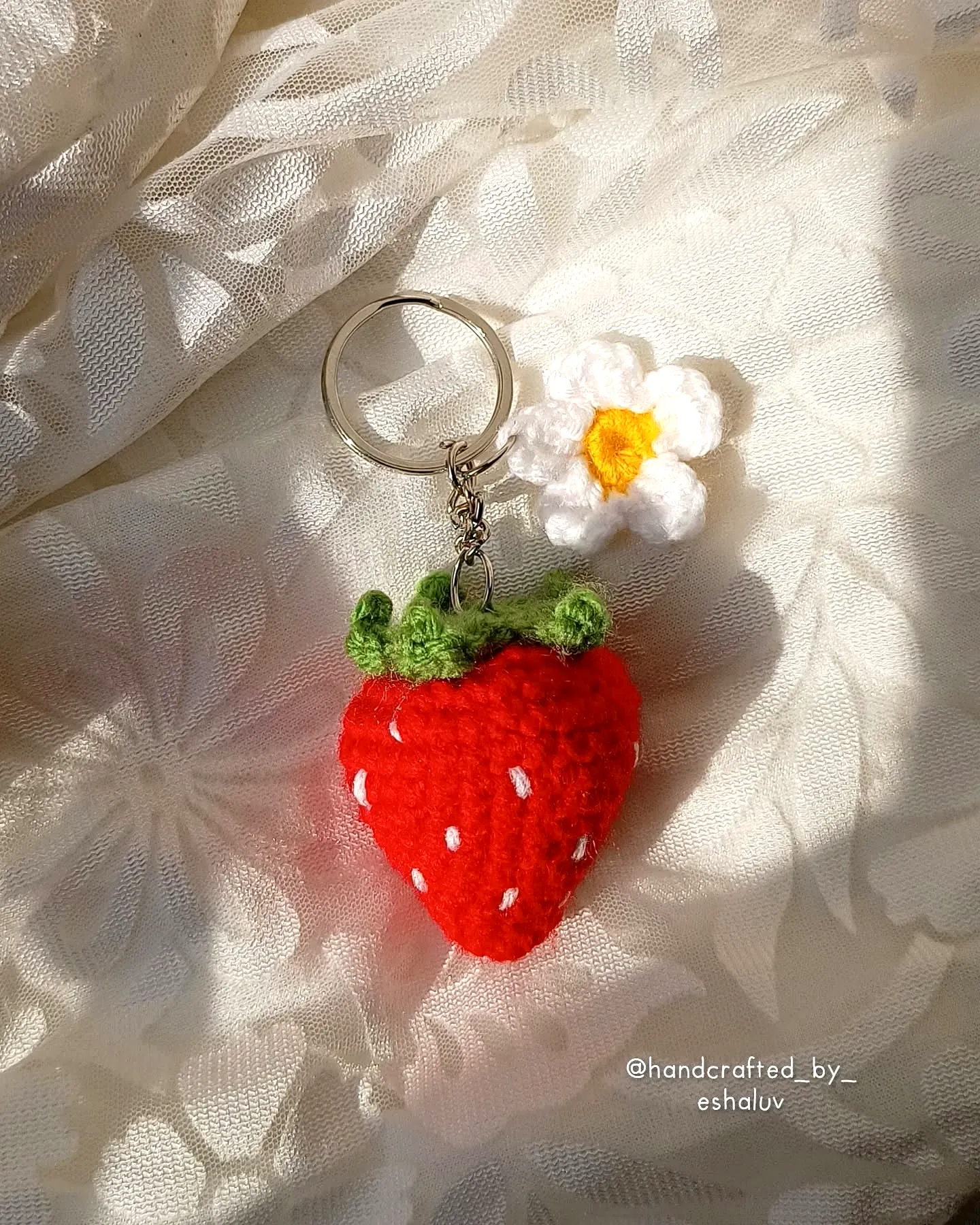 Adorable vibrant red crochet keychain with flower accent