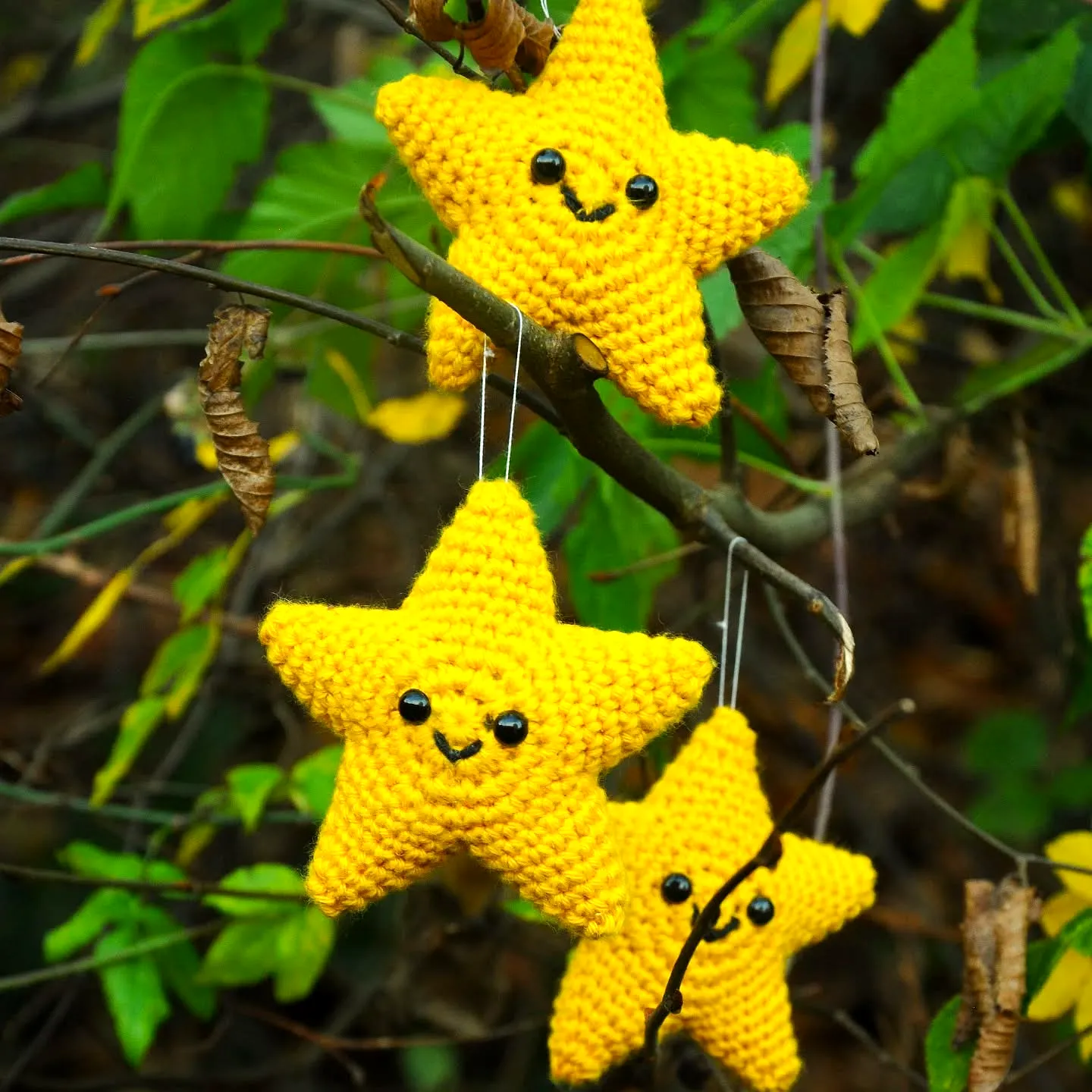 Bright Yellow Crochet Christmas Star with a Smiling Face