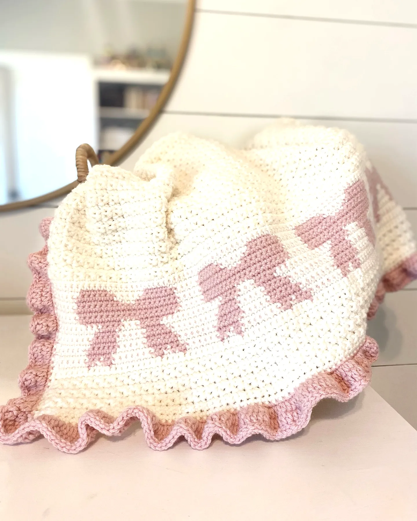 Charming Crochet Baby Blanket with Pink Bows and Ruffled Edge