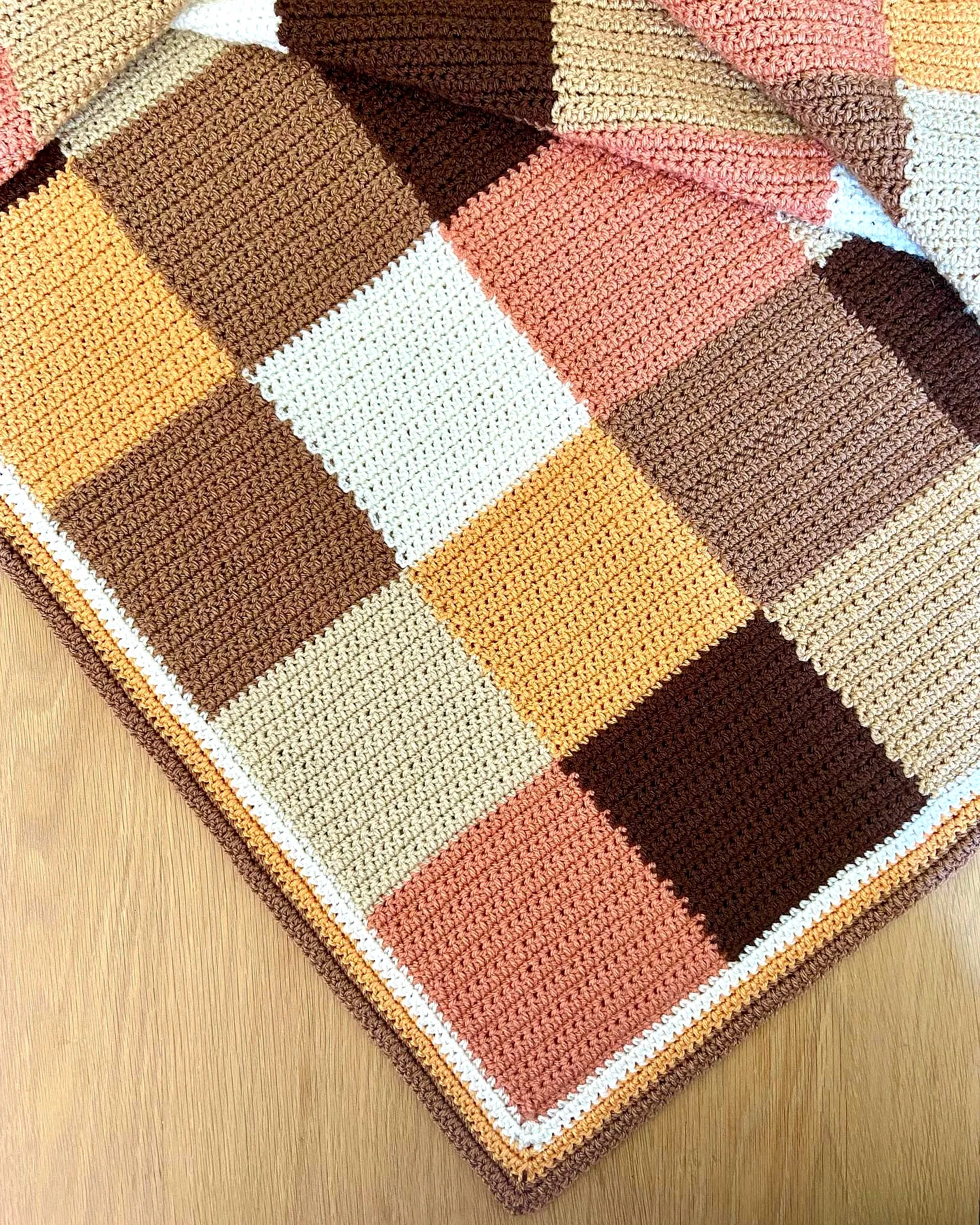 Charming Crochet Throw in Warm Colors with Stylish Patchwork Design