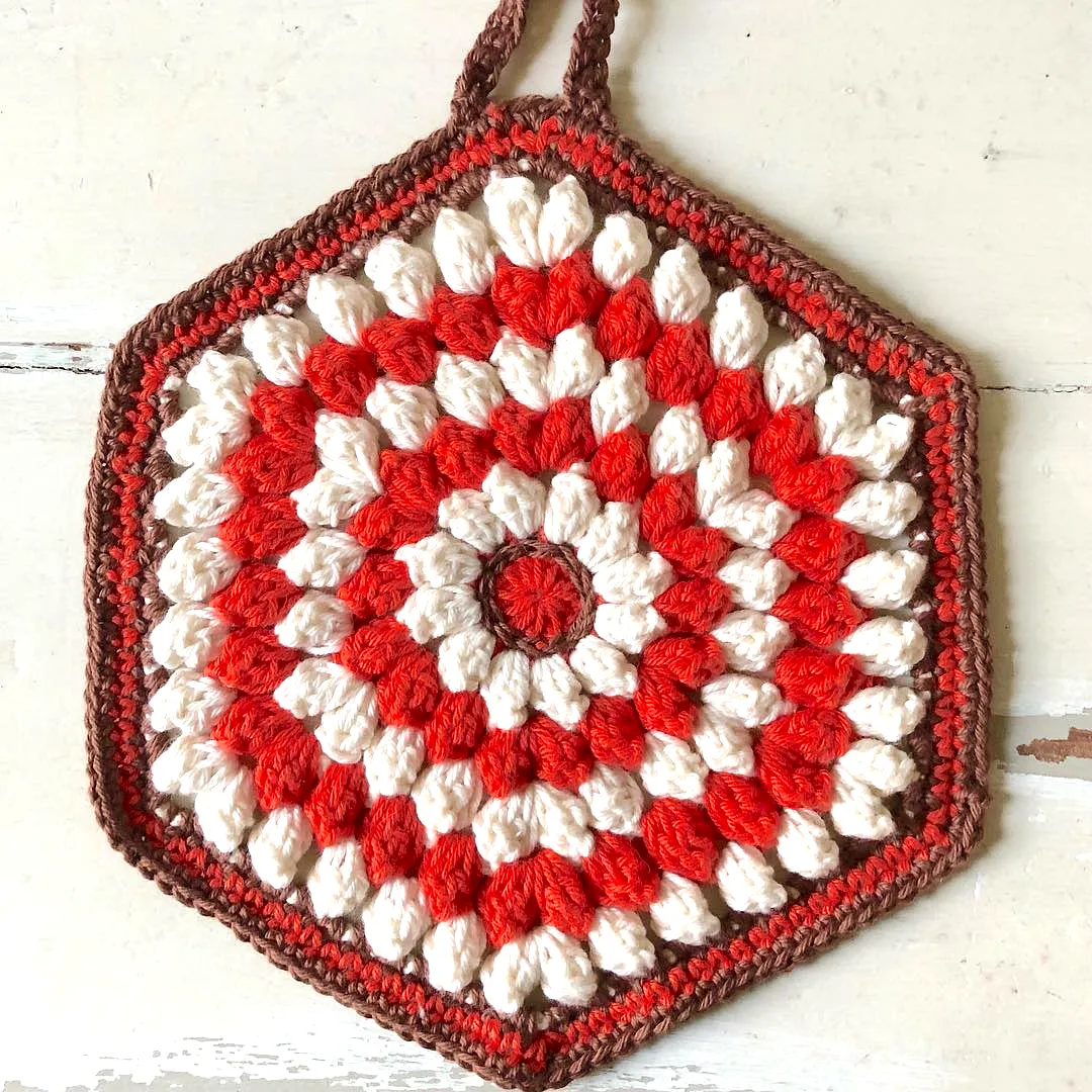 Colorful crochet pot holder with textured bobble stitch design