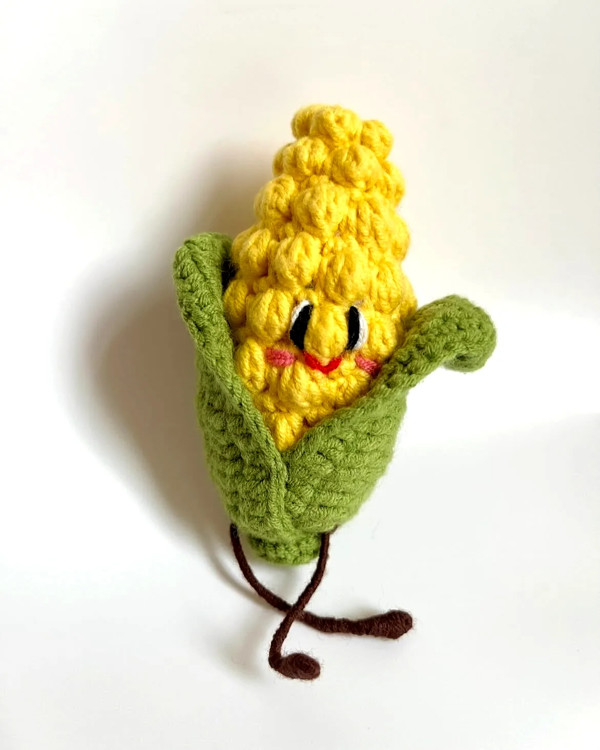Cute crochet corn plush in vibrant yellow with green leaves