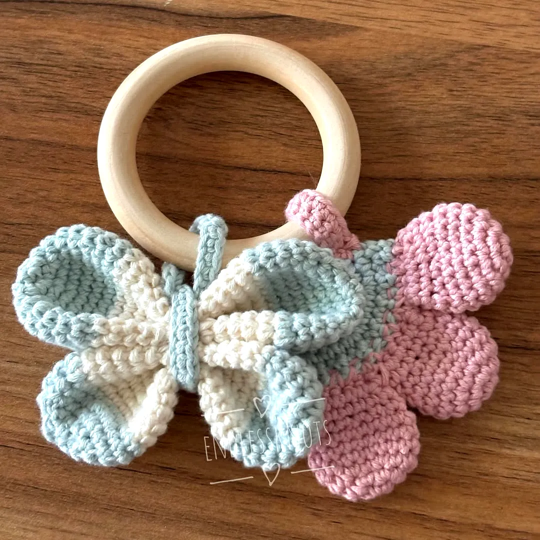 Cute pastel crochet teether with butterfly and flower design