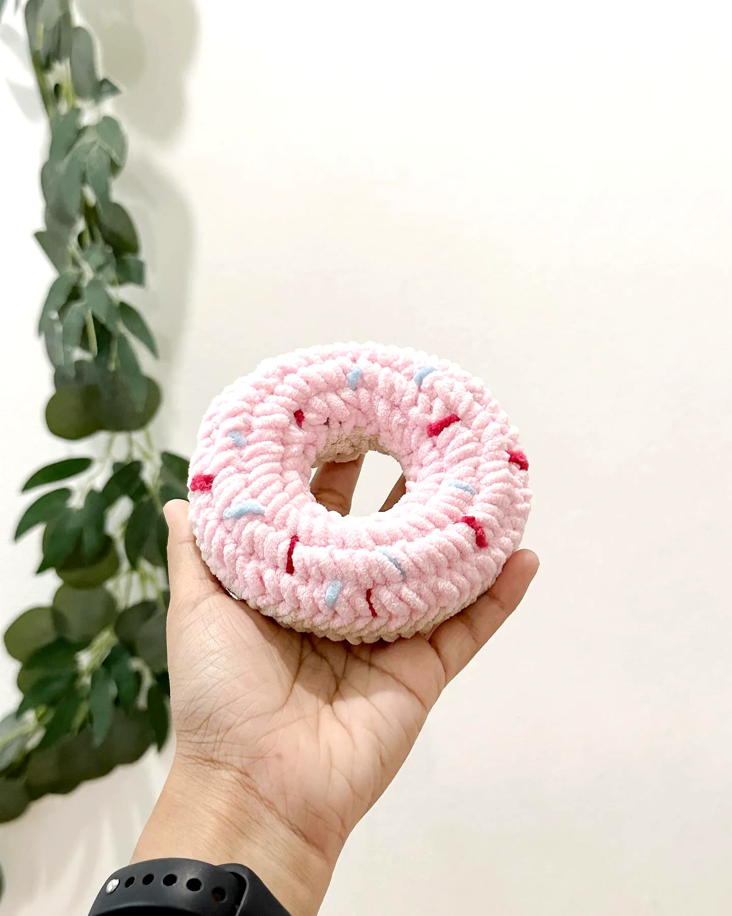 Cute pastel pink crochet donut with colorful speckles for all levels