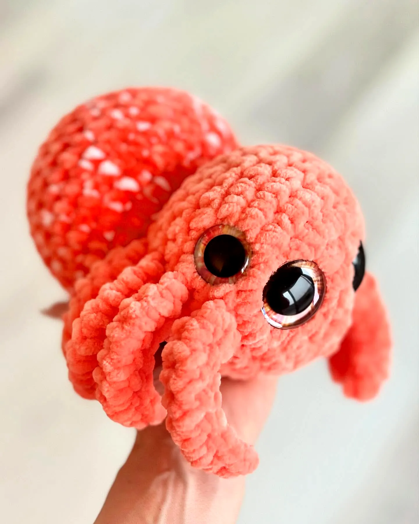 Cute vibrant coral crochet spider plush toy