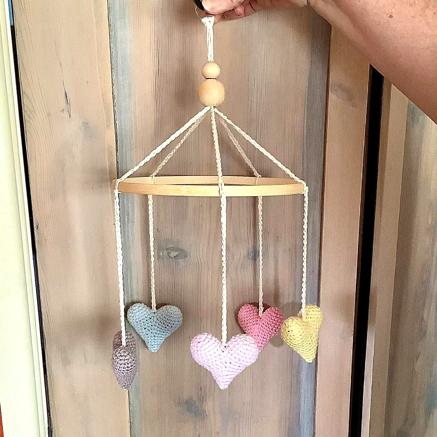 Delightful Crochet Crib Mobile with Pastel Heart Ornaments