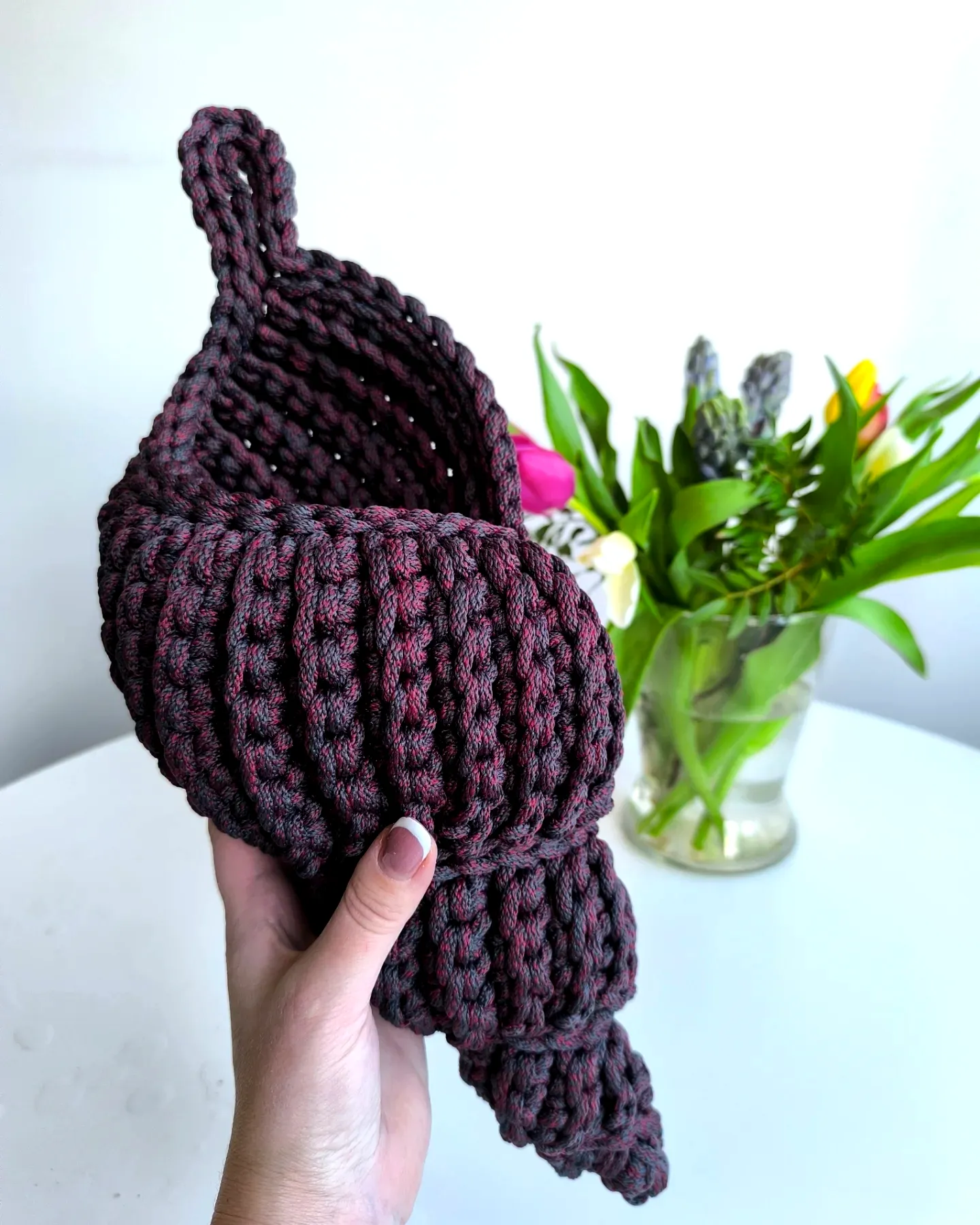 Stylish crochet basket in rich burgundy with textured spiral design