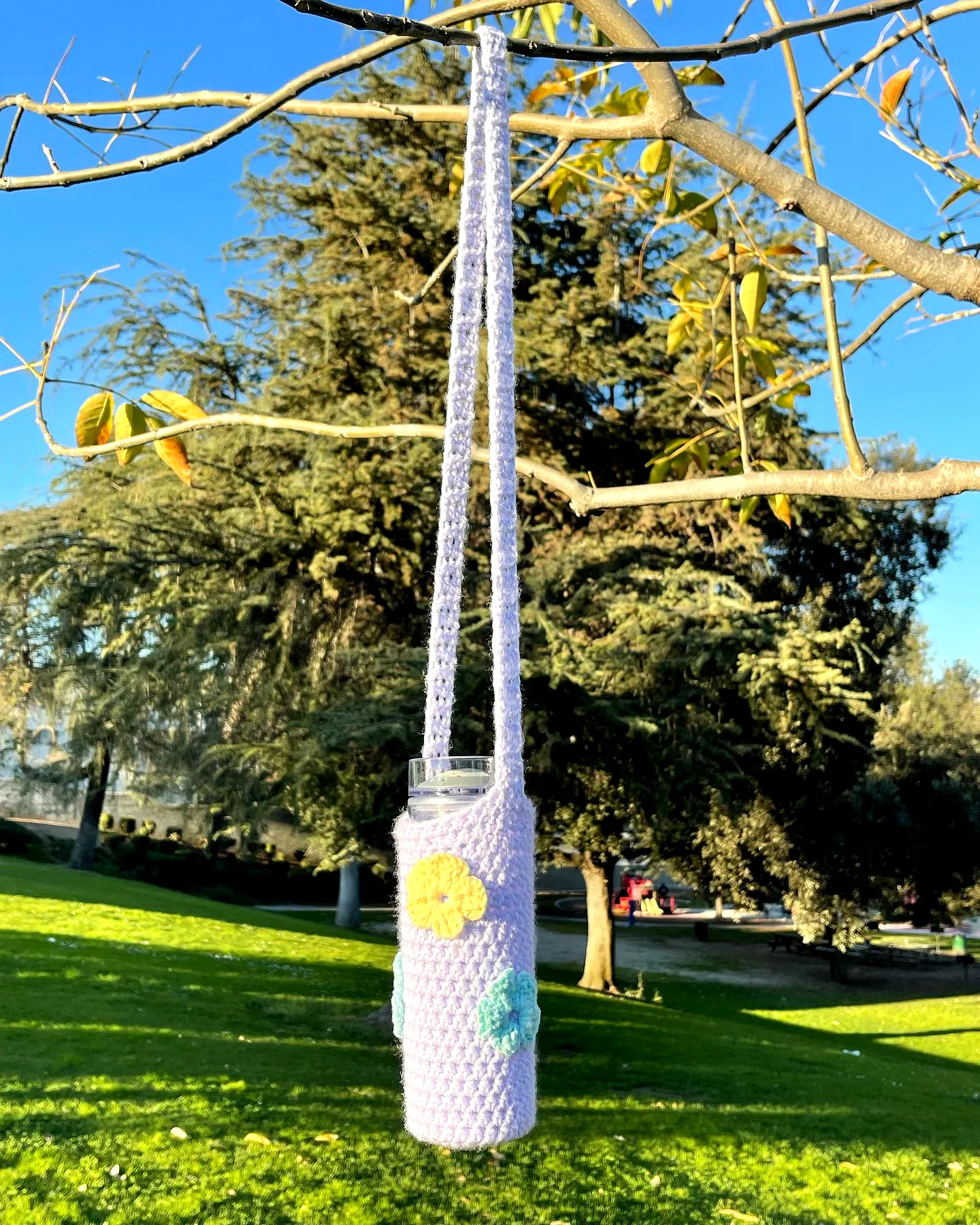 Stylish Crochet Bottle Cozy in Light Purple with Colorful Flowers