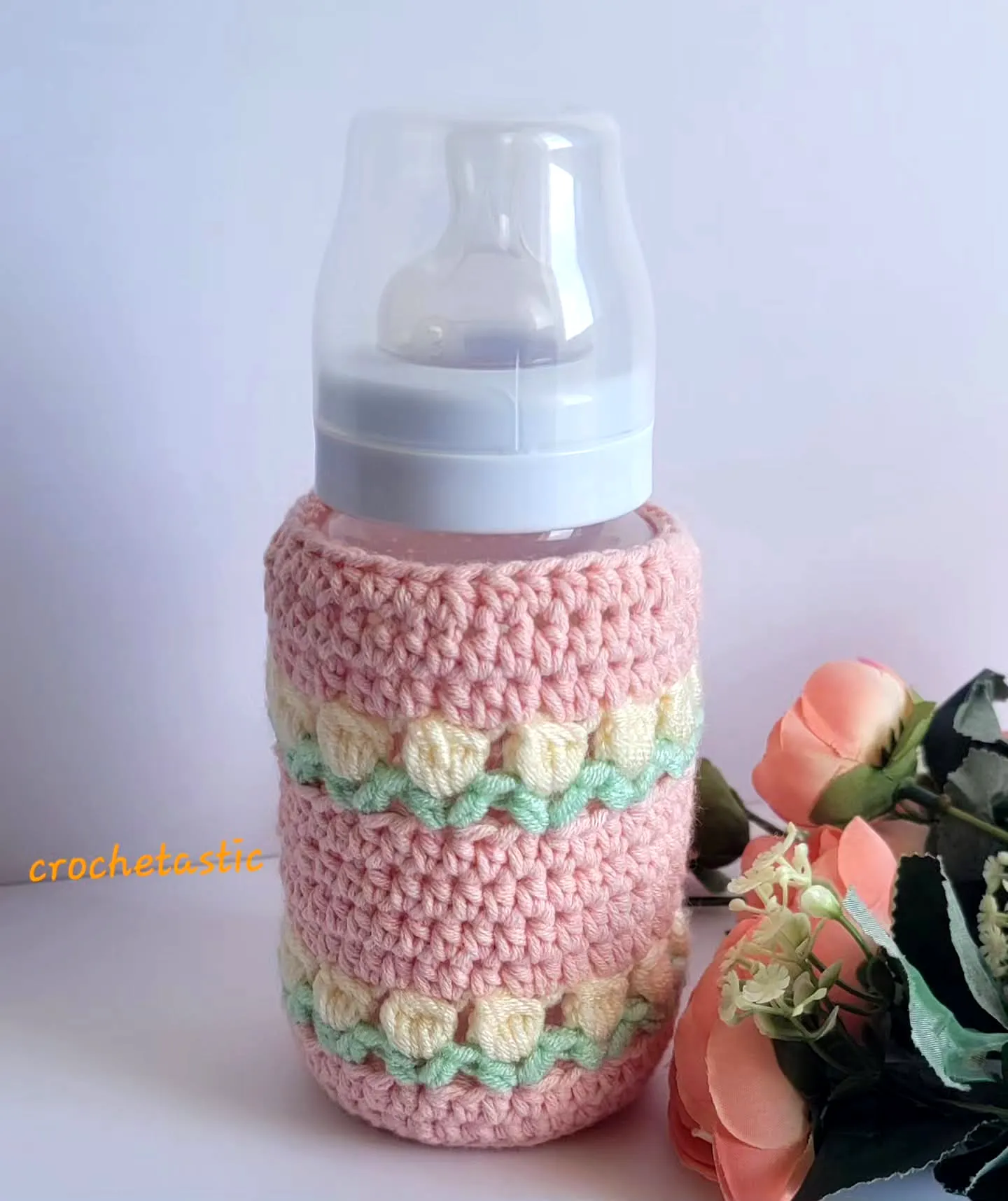 Stylish Crochet Bottle Cozy in Soft Pink with Floral Accents