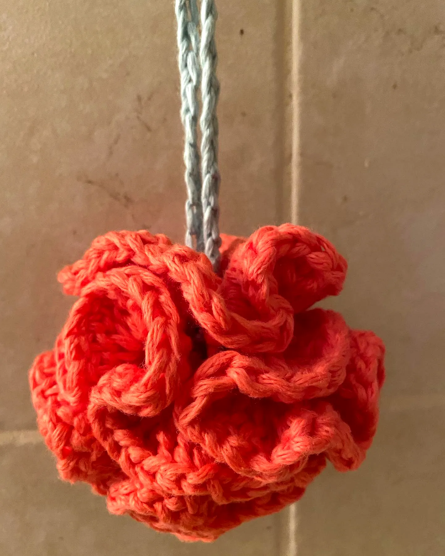 Vibrant Coral Crochet Bath Pouf with Ruffled Flower Design