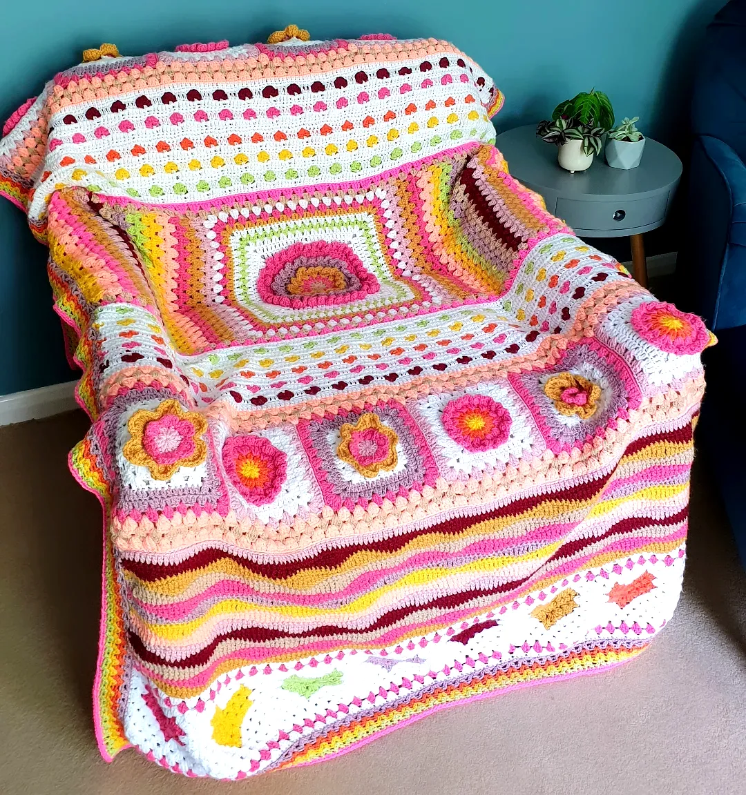 Vibrant Crochet Blanket with Floral Motifs and Stripes