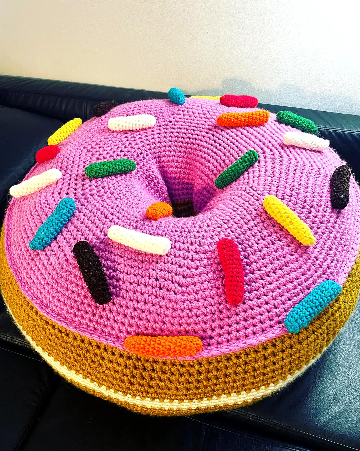 Vibrant Crochet Donut Pillow with Pink Frosting and Sprinkles