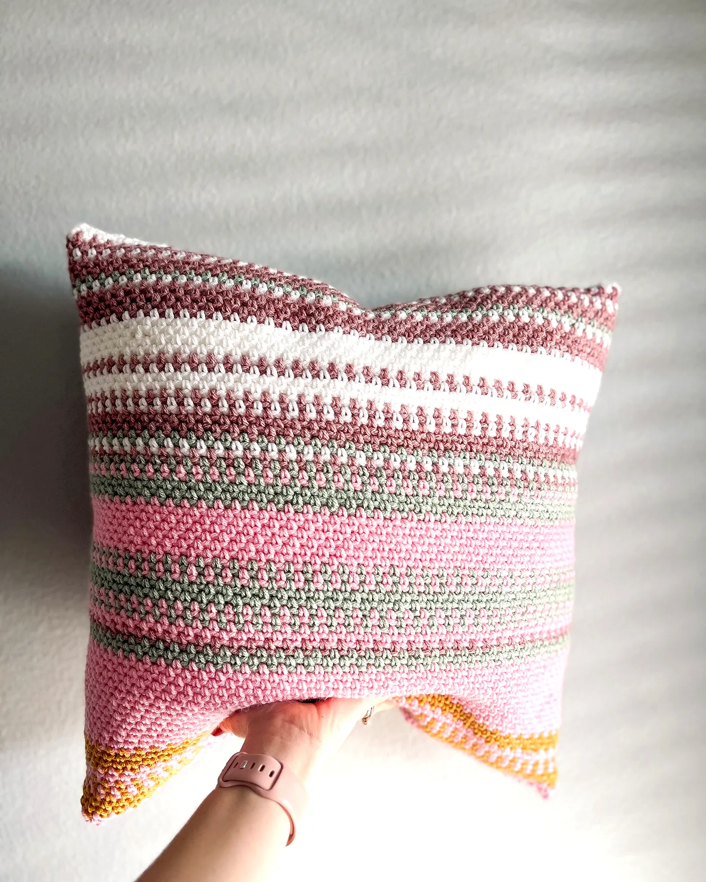 Vibrant Crochet Pillow with Colorful Stripes and Textured Stitches