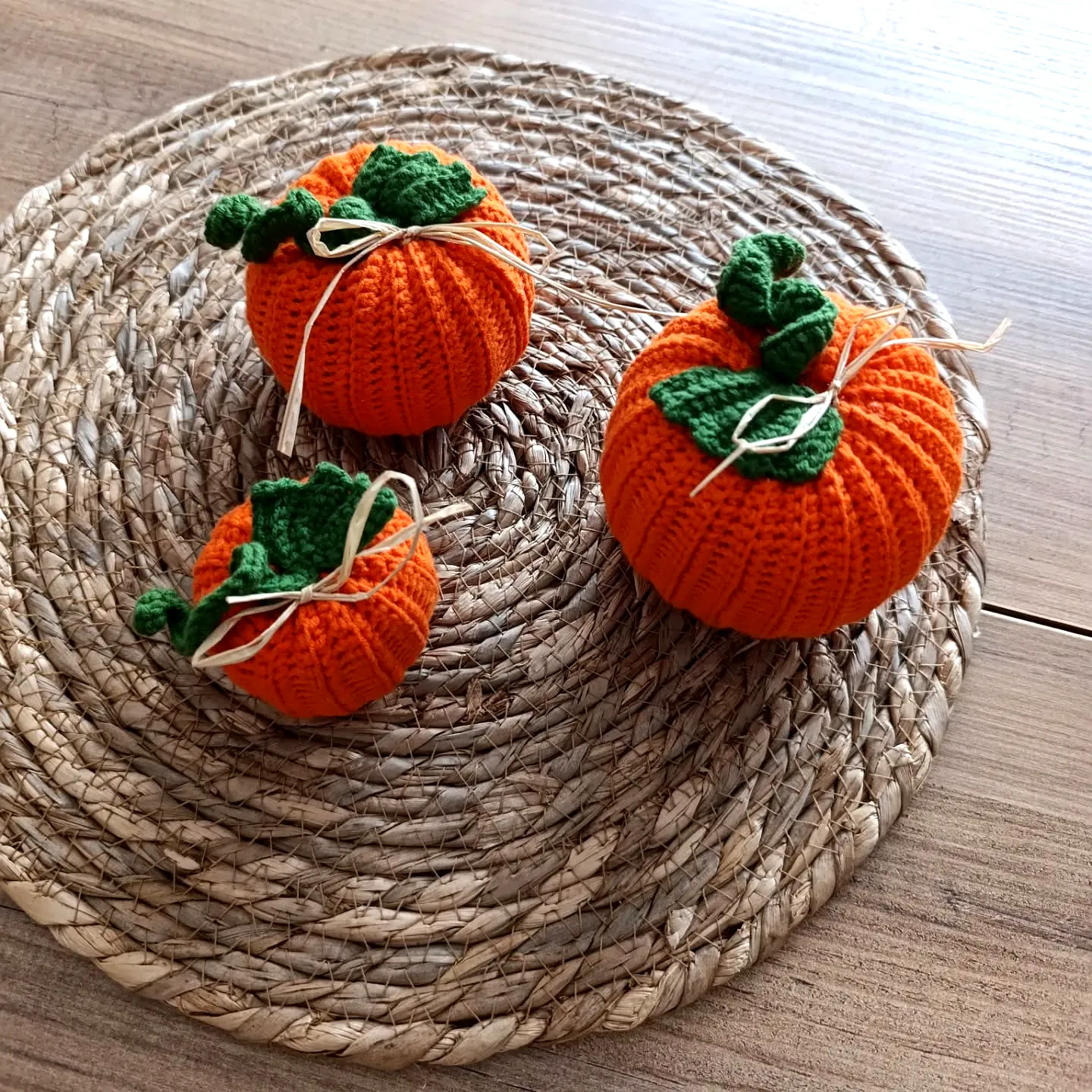 Vibrant crochet pumpkin set with textured designs and raffia accents