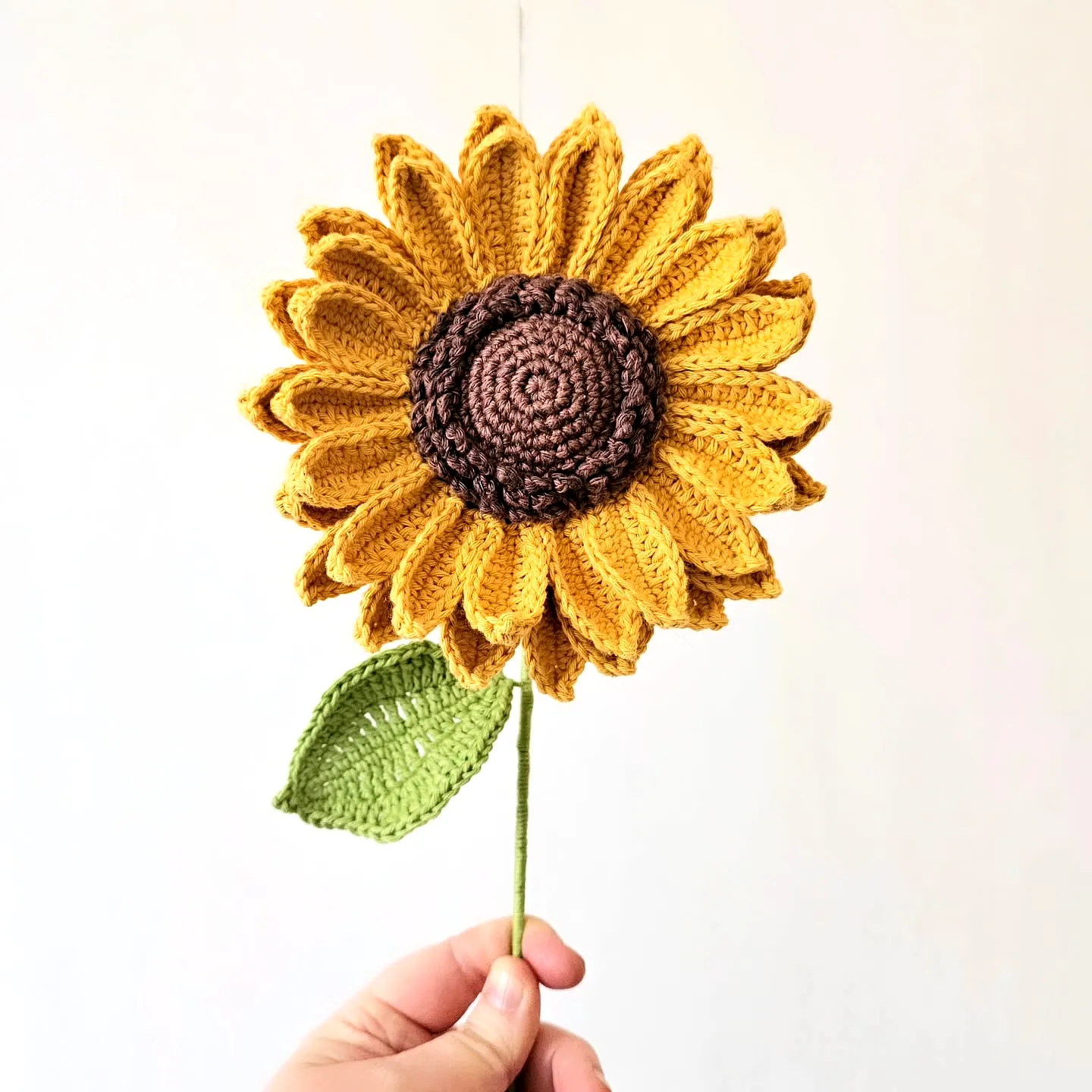 Vibrant Crochet Sunflower with Textured Center and Leaf