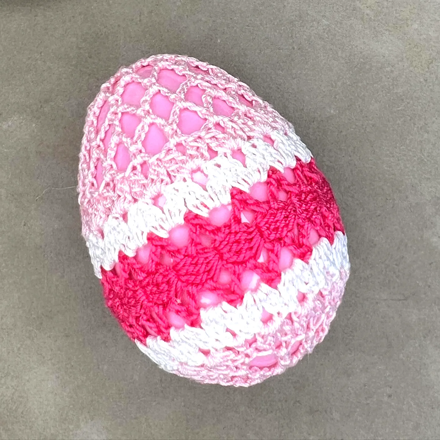 Vibrant Pink and White Crochet Easter Egg with Lacy Design